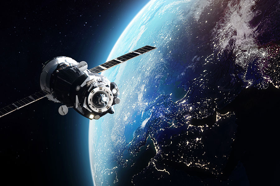 a satellite in space with earth in the background