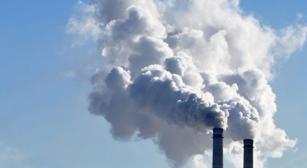 steam coming out of two factory stacks