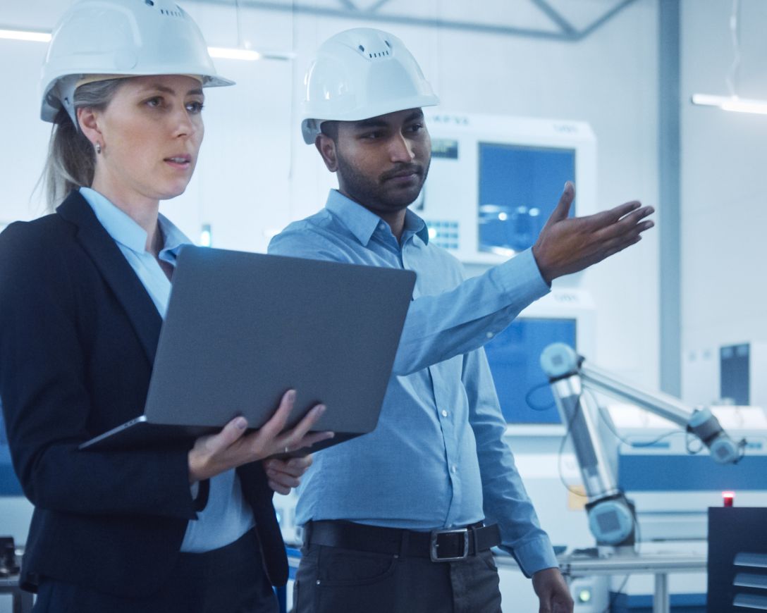 Two people with hard hats pointing