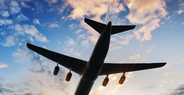 Airplane flying across a cloudy sky