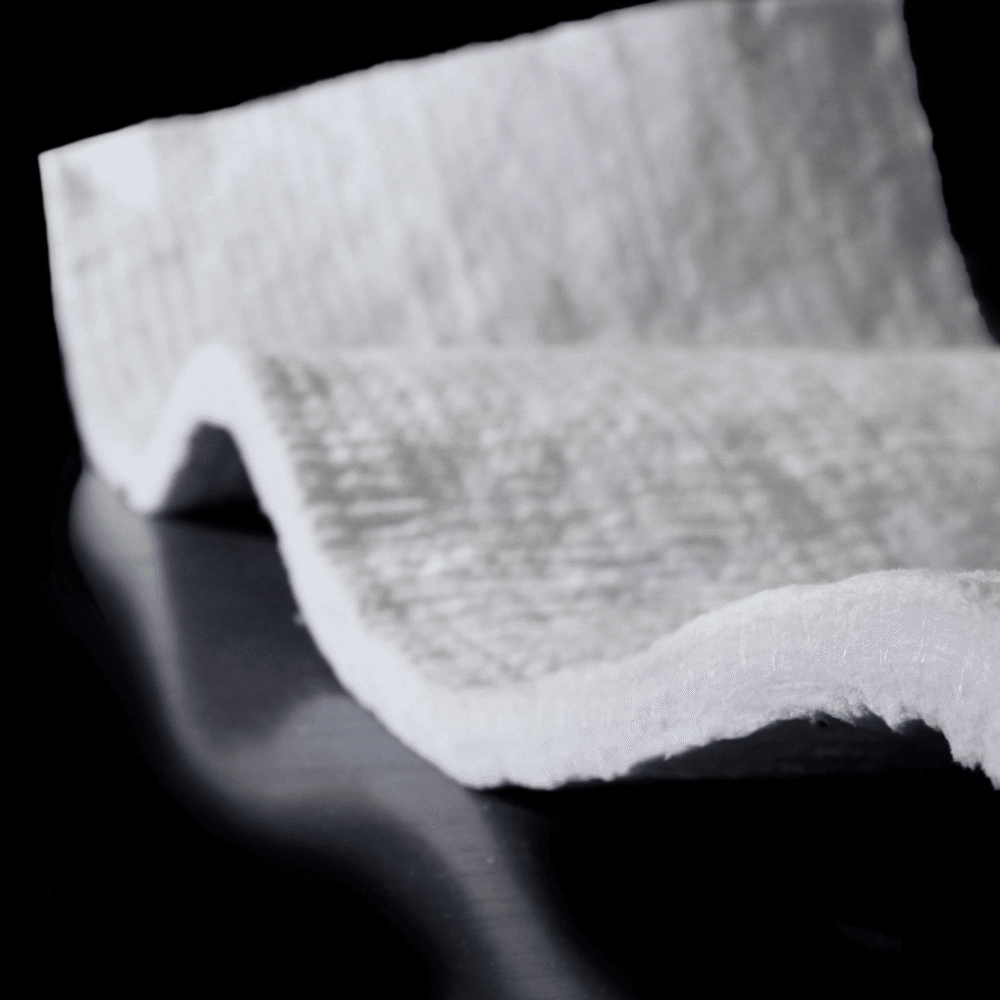 Textured white fabric on dark surface