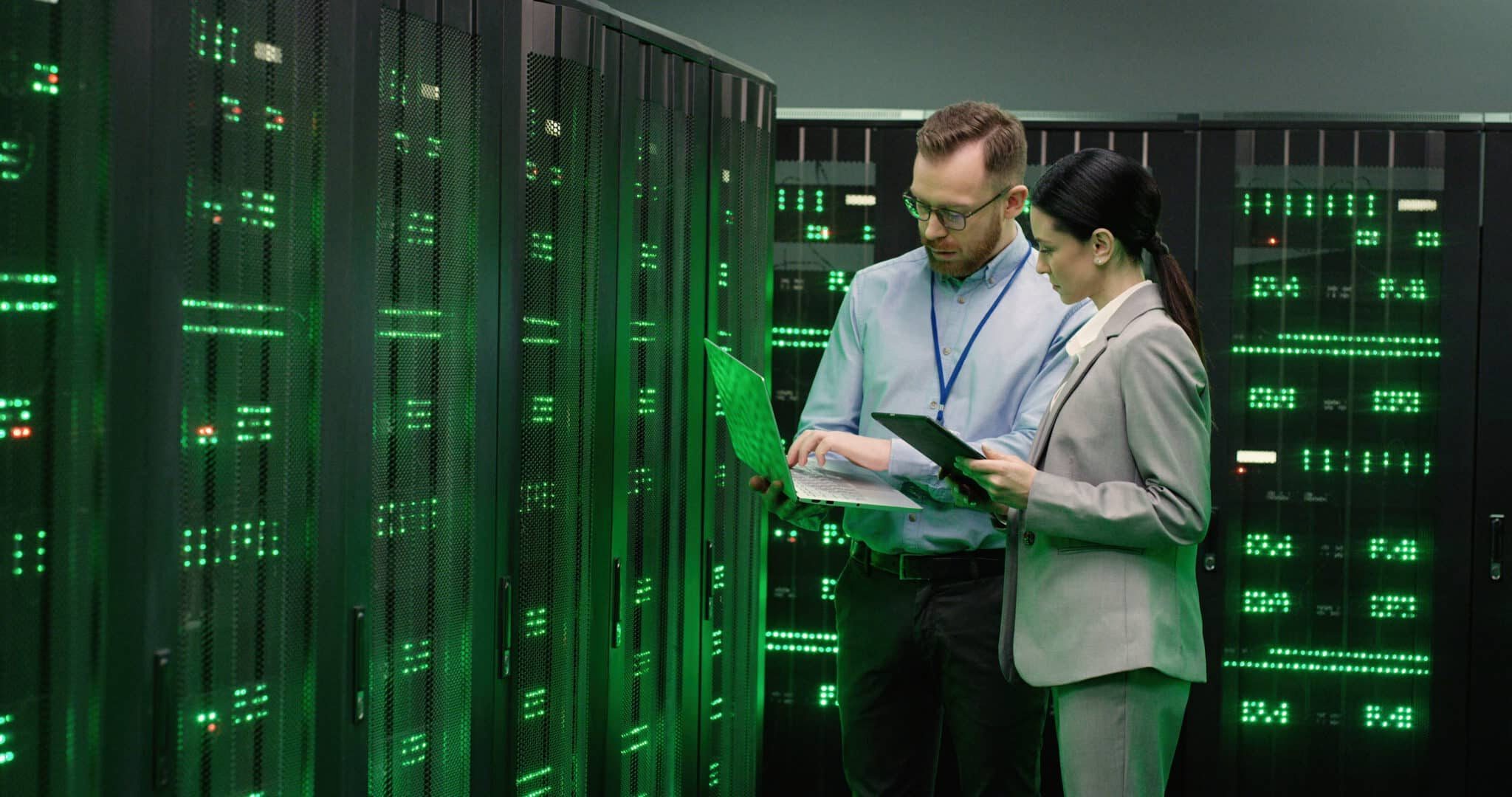 Professionals analyzing data in server room